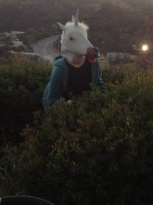 Audrey wearing a unicorn mask in the foothills of LA